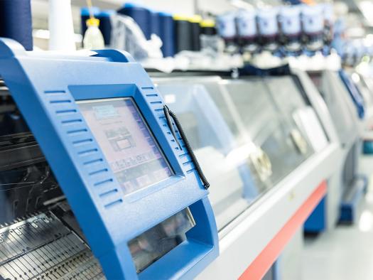 Bedienfeld einer modernen Strickmaschine in der Produktion. Bedienfeld einer modernen Strickmaschine in der Produktion.